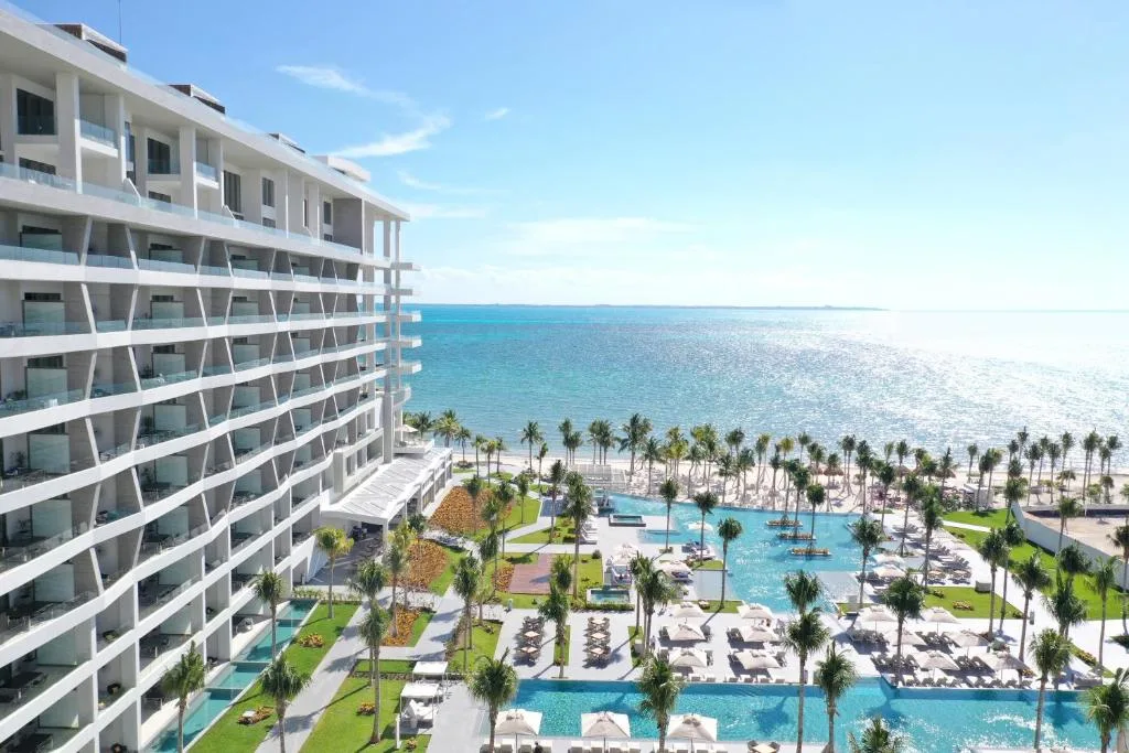 Resort tower and pools stretching to the sea