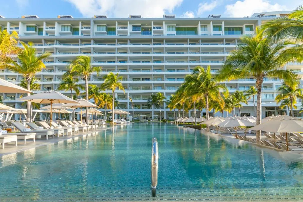 Long pool framed by palms and the resort towers