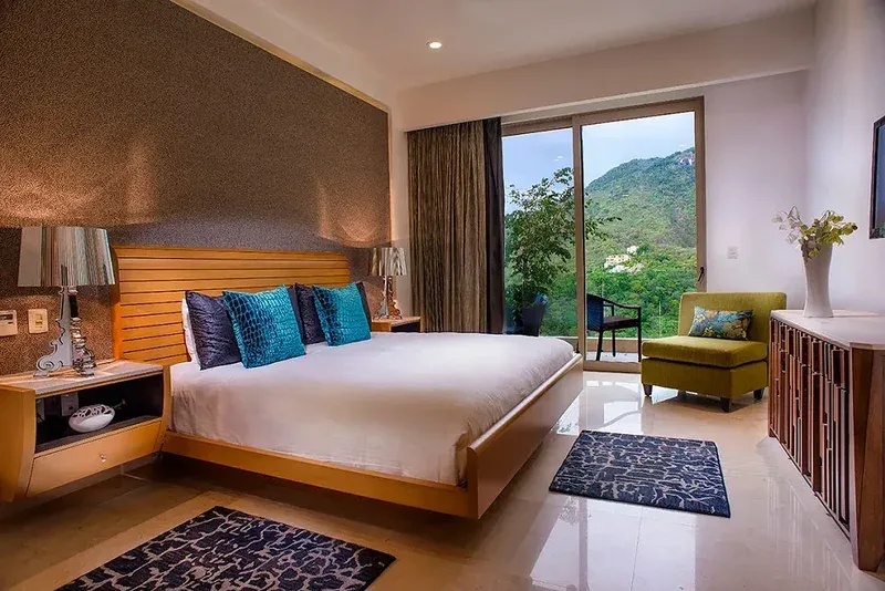 King bedroom opening onto a garden-view terrace