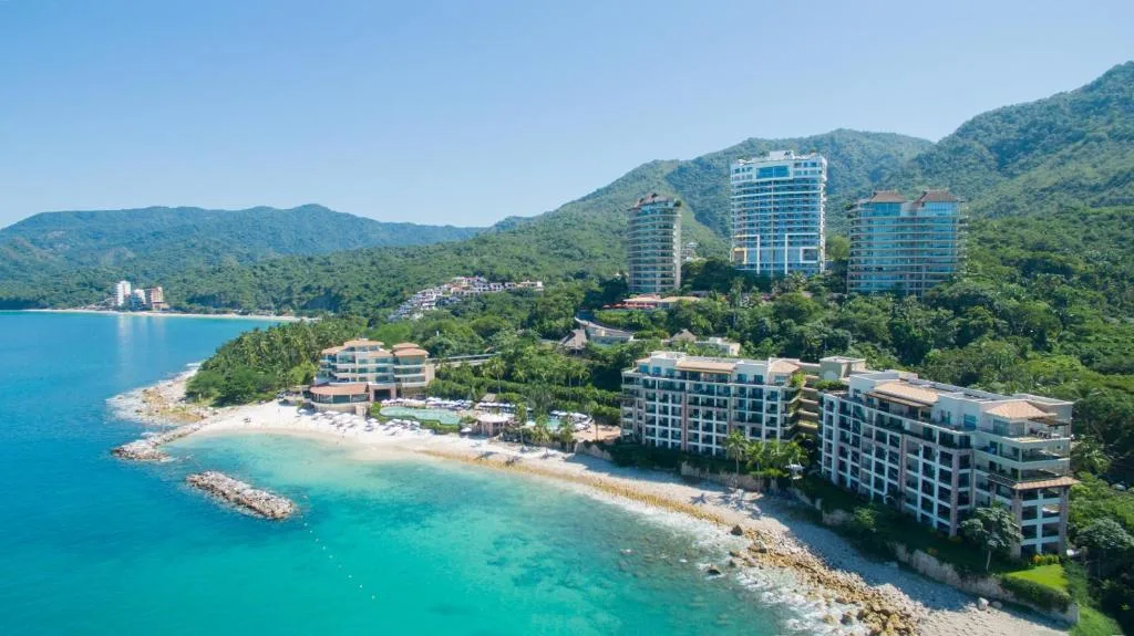 Aerial view of the resort, beach, and jungle-covered hills on Banderas Bay