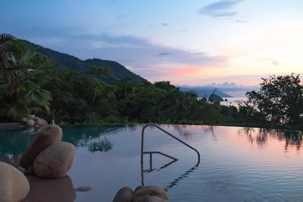 Infinity pool at dusk overlooking the bay