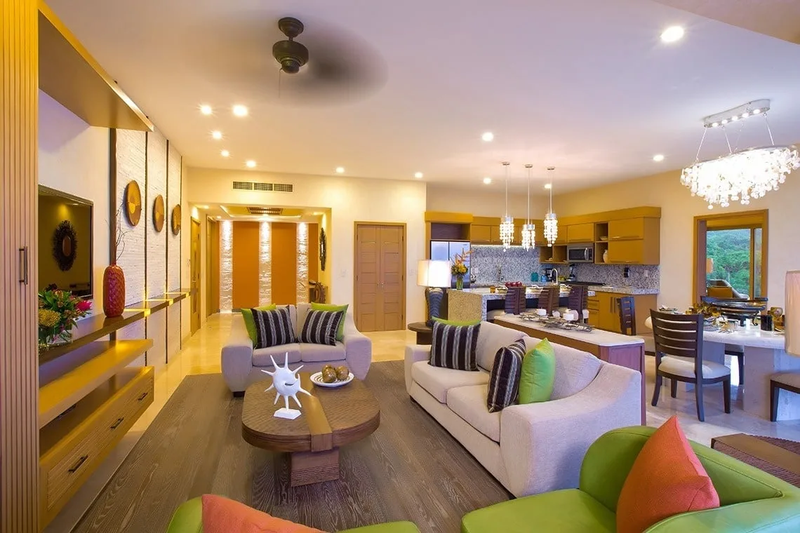Living room with entertainment center and open-plan kitchen