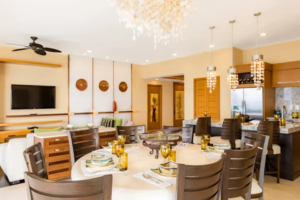 Dining table for eight beneath shell chandeliers
