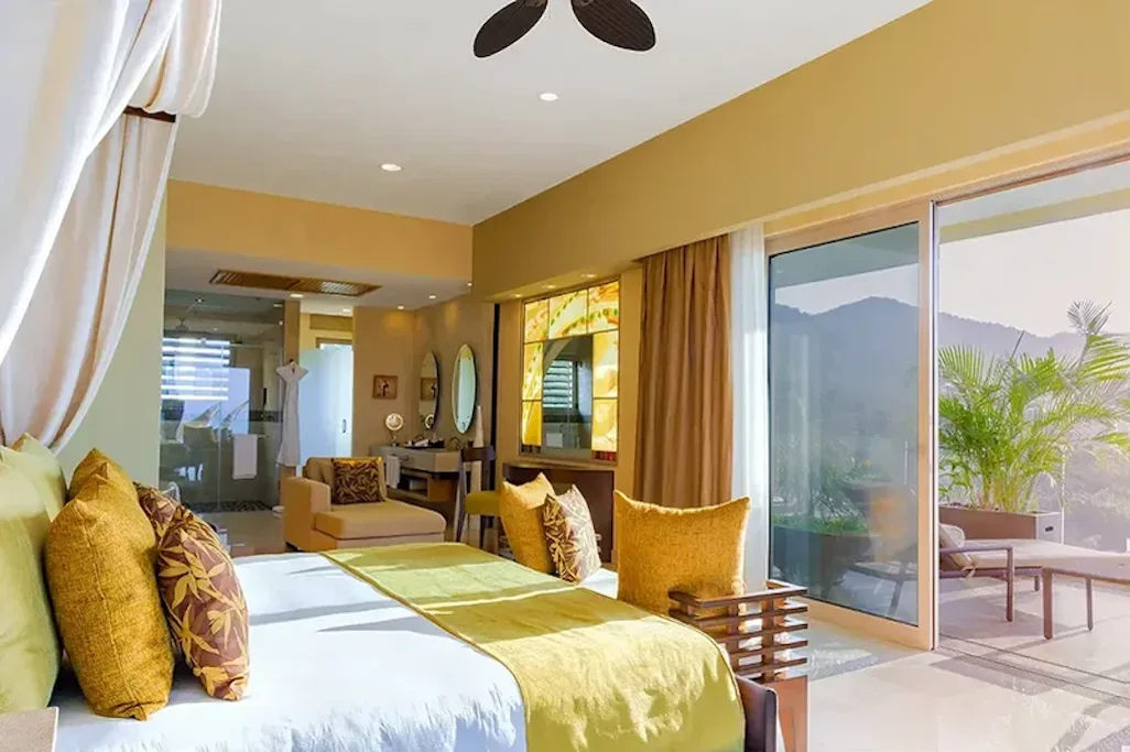 Bedroom opening onto a private terrace with mountain views
