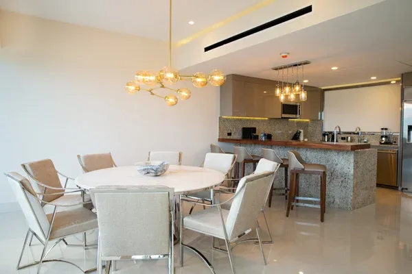 Dining area and fully equipped kitchen with breakfast bar